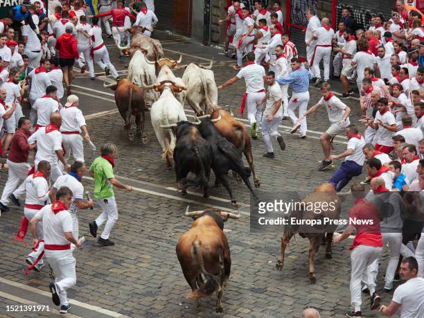 Crowds of people run during the first running of the bulls of the Fiestas de San Fermin 2023, with bulls from Puerto de San Lorenzo, on July 7 in...