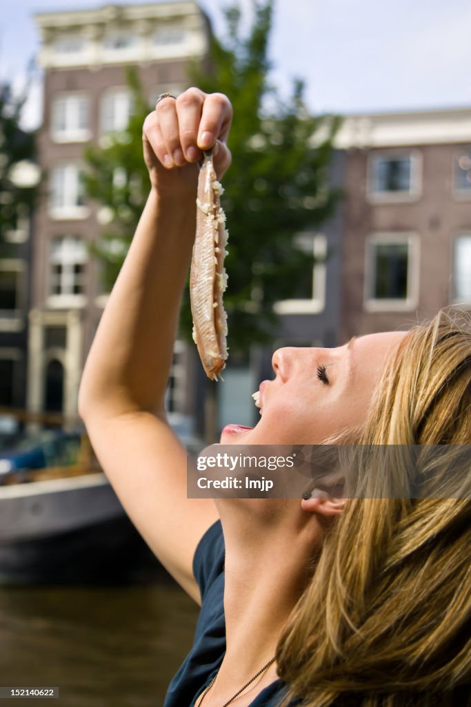 Dangling Fish From Ciling A Woman Dangling Fish Above Her Mouth High-Res Stock Photo - Getty Images