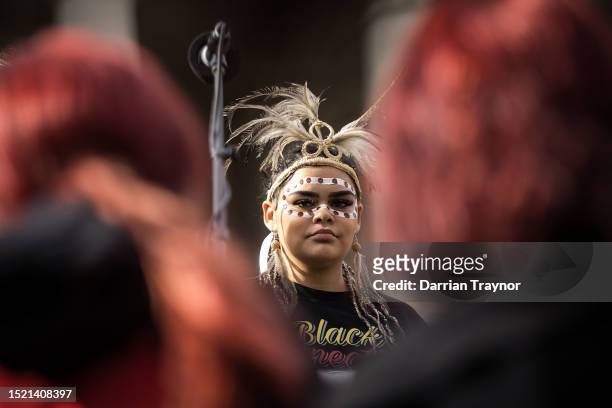 Young Woman listens to speeches given on the steps of Victoria's Parliament House during the NAIDOC March on July 07, 2023 in Melbourne, Australia....