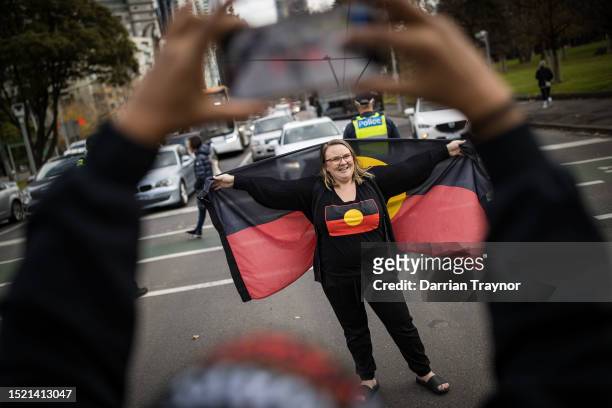 Woman takes a photograph during the NAIDOC March on July 07, 2023 in Melbourne, Australia. NAIDOC Week is an Australian observance lasting from the...