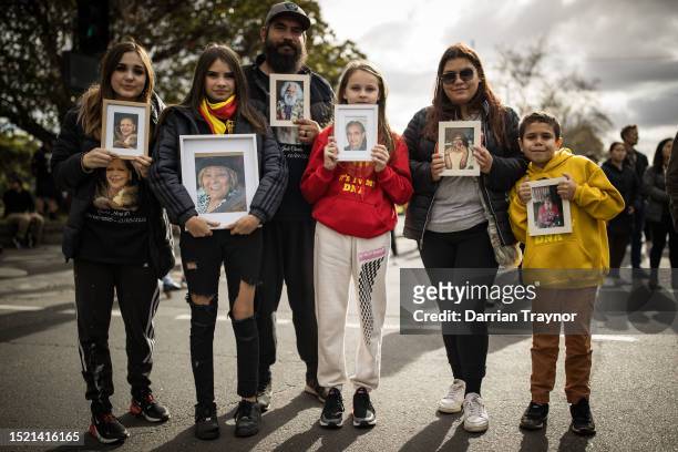 Family poses holding photos of their elders and family members who have passed away during the NAIDOC March on July 07, 2023 in Melbourne, Australia....