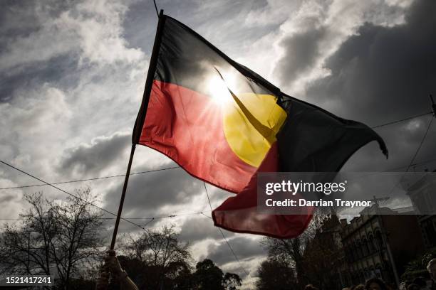 The Aboriginal flag is seen flying during the NAIDOC March on July 07, 2023 in Melbourne, Australia. NAIDOC Week is an Australian observance lasting...