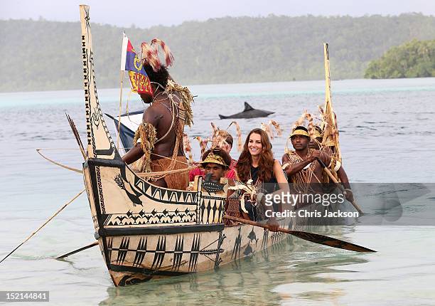Catherine, Duchess of Cambridge and Prince William, Duke of Cambridge travel in a traditional canoe during a visit to Tuvanipupu Island on their...