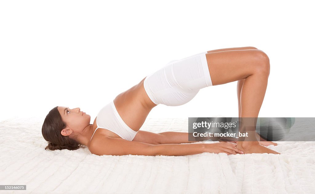 Yoga pose - female in sport clothes performing exercise