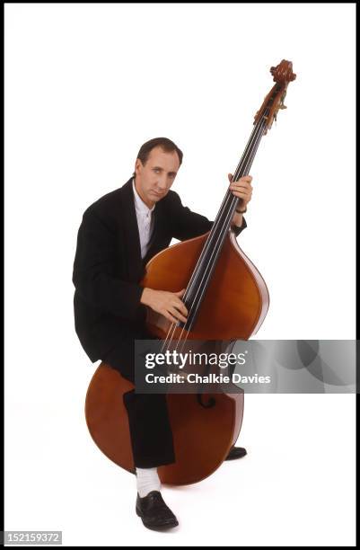 English guitarist Pete Townshend of The Who, playing a double bass, London, November 1985.