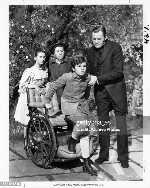 Margaret O'Brien and Brian Roper watch as Dean Stockwell attempts to walk with the help of Herbert Marshall in a scene from the film 'The Secret...