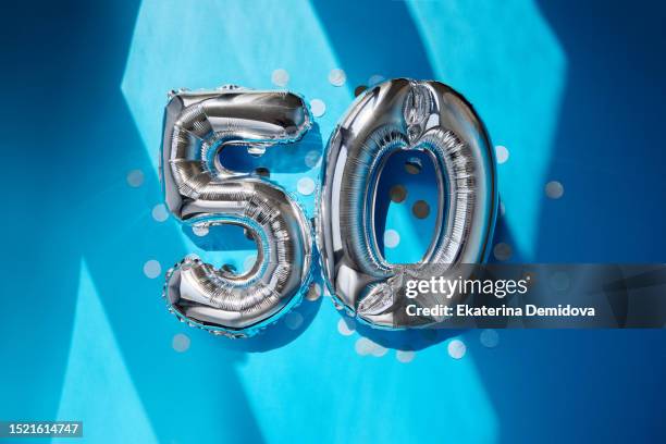 silver numbers 50 fifty years balloons in sunlight blue background - number 50 imagens e fotografias de stock