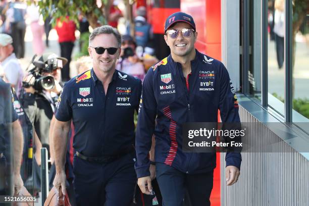 Sergio Perez of Mexico and Oracle Red Bull Racing talks with Red Bull Racing Team Principal Christian Horner in the Paddock prior to practice ahead...