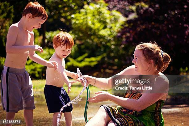 water play - two kids playing with hose stock pictures, royalty-free photos & images