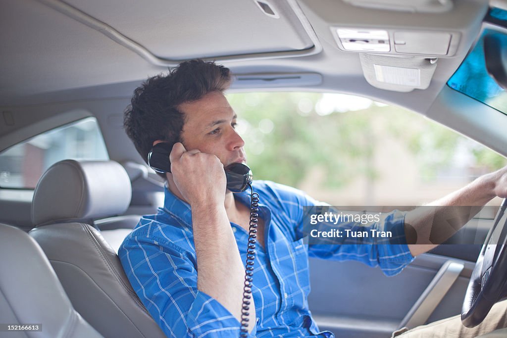 Man in car with telephone