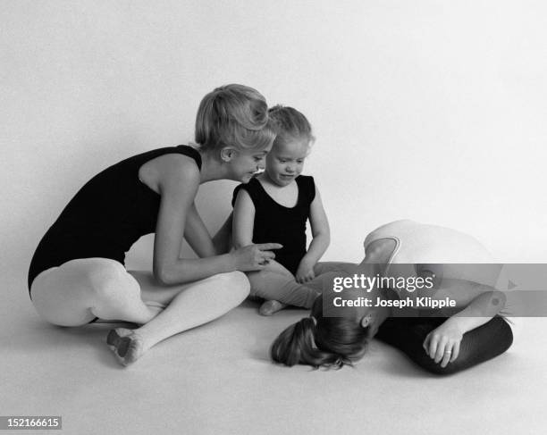 American dancer and dance instructor, and future actress, Goldie Hawn instructs two of her young ballet students, Arlington, Virginia, September 29,...