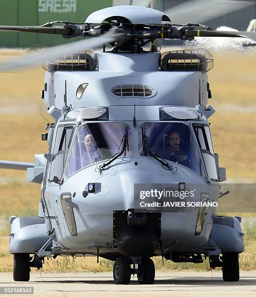 An NH90 helicopter carrying Spain's King Juan Carlos lands at the Cuatro Vietos Military Air Base in Madrid on September 17, 2012 during a press...