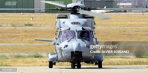 An NH90 helicopter carrying Spain's King Juan Carlos lands at the Cuatro Vietos Military Air Base in Madrid on September 17, 2012 during a press...