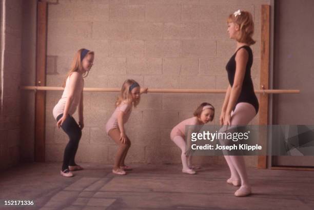 American dancer and dance instructor, and future actress, Goldie Hawn demonstrates a position for her young ballet students, Washington DC, 1964.