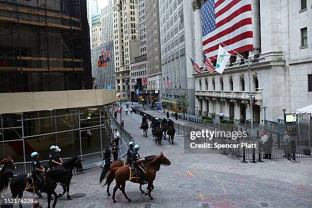 Police on horseback keep guard along Wall Street during 'Occupy Wall Street' demonstrations on September 17, 2012 in New York City. The 'Occupy Wall...
