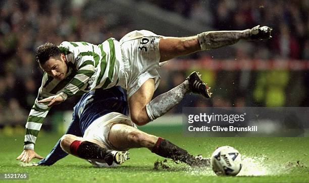 Mark Viduka of Glasgow Celtic is tackled by Craig Moore of Glasgow Rangers during the Scottish Premier Division game between Glasgow Celtic and...
