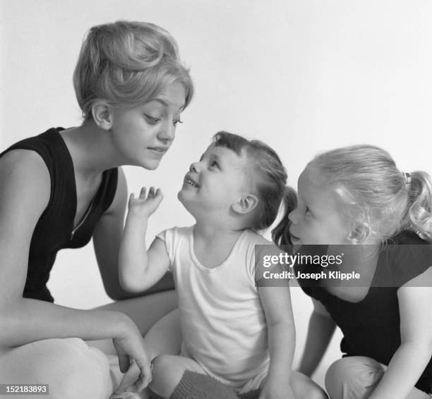 American dancer and dance instructor, and future actress, Goldie Hawn poses with two of her young ballet students, Arlington, Virginia, September 29,...