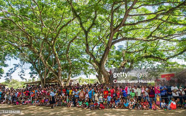 Locals wait to greet Catherine, Duchess of Cambridge and Prince William, Duke of Cambridge at a cultural village on their Diamond Jubilee tour of the...