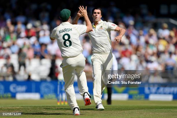 Pat Cummins of Australia celebrates with Mitchell Marsh after dismissing Joe Root of England during Day Two of the LV= Insurance Ashes 3rd Test Match...