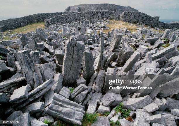The Fort of Dun Aengus on the Isle of Inishmore, Said to have been built by the mythical race the Fir Bholg. The stones in the foreground are part of...