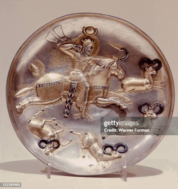 Plate with depiction of a king hunting stags or ibex, By his crown he is identified as either Peroz or Kavad I. Ancient Middle East. Sasanian 5th 6th...