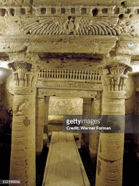 The extensive complex of burial chambers at Kom el-Shuqafa, combining Greek and Egyptian design elements, View of a columned entrance way with...