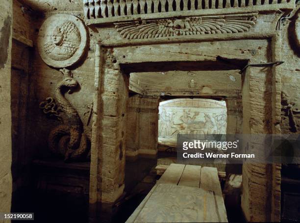 The extensive complex of burial chambers at Kom el-Shuqafa, combining Greek and Egyptian design elements, View of a relief carving of a snake/dragon,...