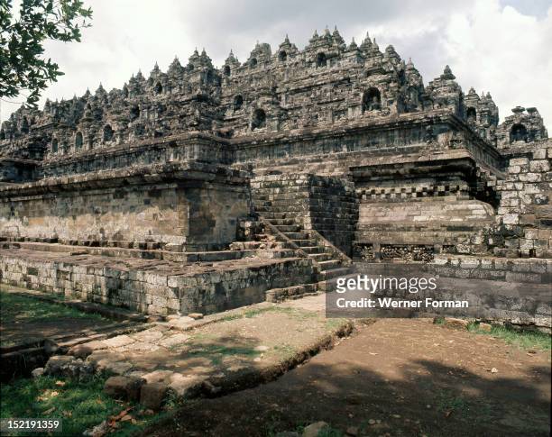 View of the terraces, Borobudur, There are many Buddha figures set into niches in the walls. They symbolise projections of the single...
