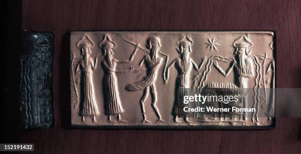 Cylinder seal of the water god Ea with streams flowing from his body, It illustrates the myth in which the bird man Zu is led before his judge Ea,...