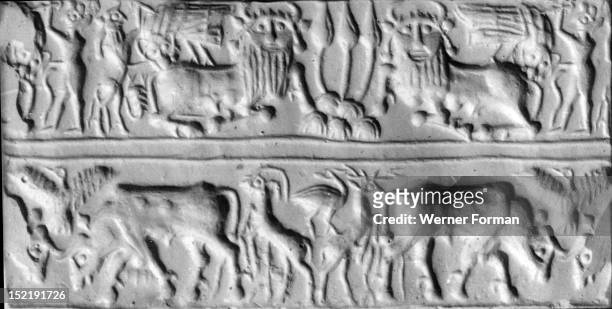 Cylinder seal with two registers, On the upper register two bull men crouch on either side of a triple plant on a stylised mountain, possibly...