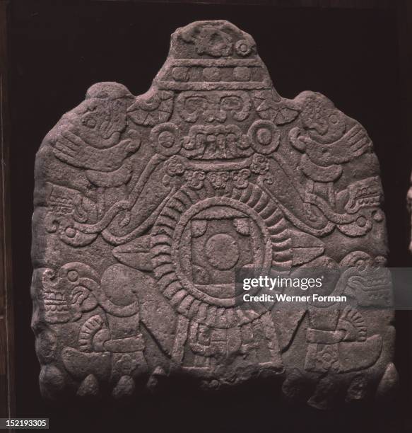 Relief showing Tlaloc as Lord of Tlalocan, identified by his four teeth, Attached to his limbs are the skulls of the dead who have entered his...