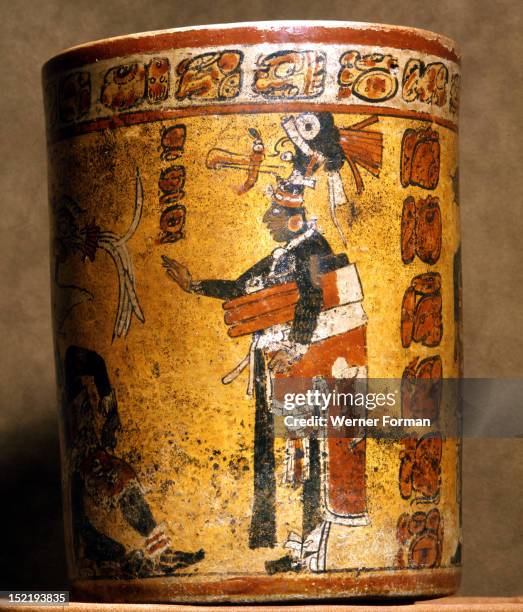 Cylindrical vessel decorated with date glyphs and a Mayan ball player wearing black body paint and heavy padding for the competition, The great yoke...