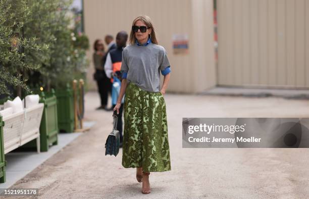 Guest seen outside Elie Saab show wearing big black sunnies, grey tshirt with blue shirt underneath, rose printed maxi skirt and Gucci Donysus...