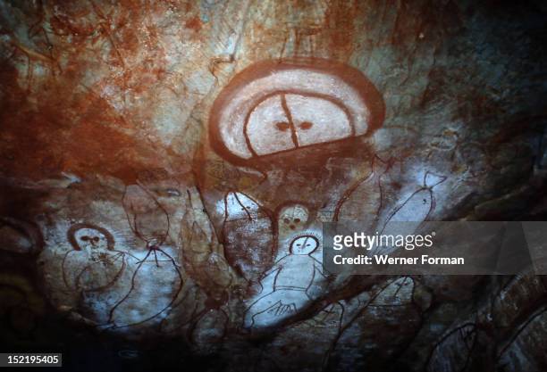 Aboriginal cave painting of a Wandjina, The Wandjina are a group of ancestral beings from the sea and sky that bring rain and control the fertility...