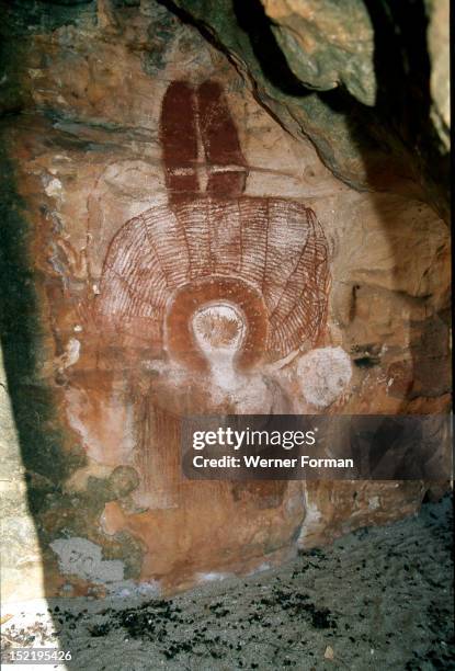 Aboriginal cave painting of a Wandjina, The Wandjina are a group of ancestral beings from the sea and sky that bring rain and control the fertility...