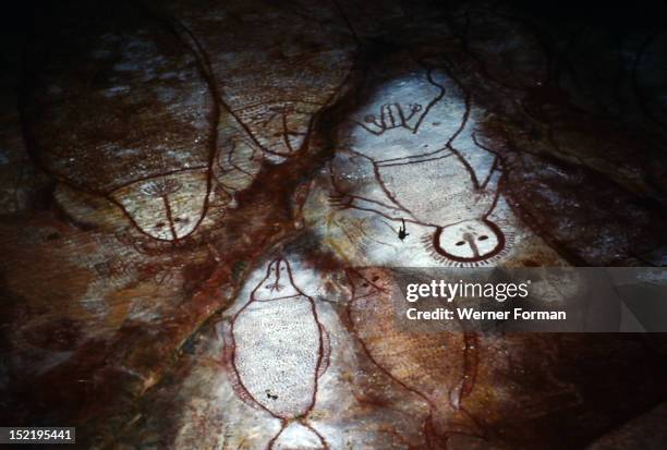 Aboriginal painting on a cave ceiling of a Wandjina, The Wandjina are a group of ancestral beings from the sea and sky that bring rain and control...
