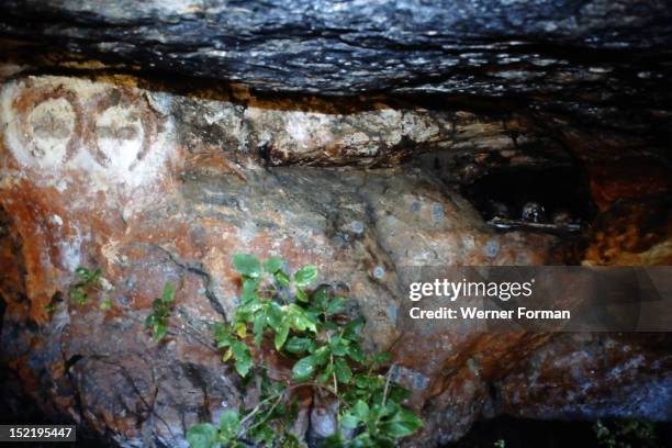 Aboriginal rock of two Wandjina Heads with a burial niche close by, Australia. Aboriginal. King Edward River, Kimberley region .