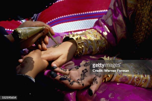 Geometric and floral decorative henna patterns were applied to adorn the hands and feet of young women on occasions such as weddings, The black dye...