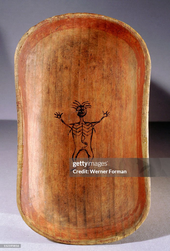 The base of a bentwood serving dish decorated with the figure of a man