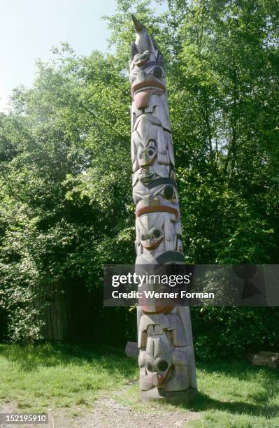 Totem pole with ceremonial crests, Totem poles were usually erected at potlatches and formed the link between the natural phenomena and the human...