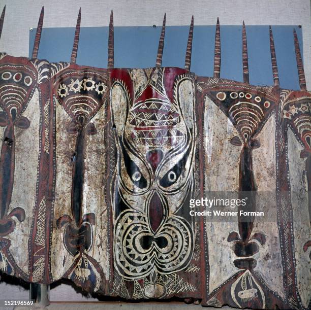 Painted sheets of bark cloth, called tapa, used as magical ornaments in ceremonial ghost houses to which only the men were admitted, New Guinea....