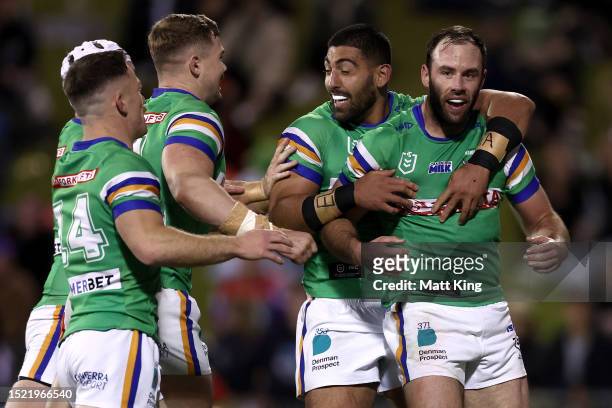 Matt Frawley of the Raiders celebrates with team mates after scoring a try during the round 19 NRL match between St George Illawarra Dragons and...