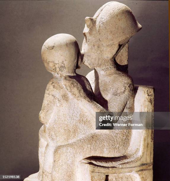 Akhenaton kisses his daughter as she sits on his lap, An unfinished statue. Egypt. Ancient Egyptian. Amarna period c 1373 1357 BC. Tell el Amarna.