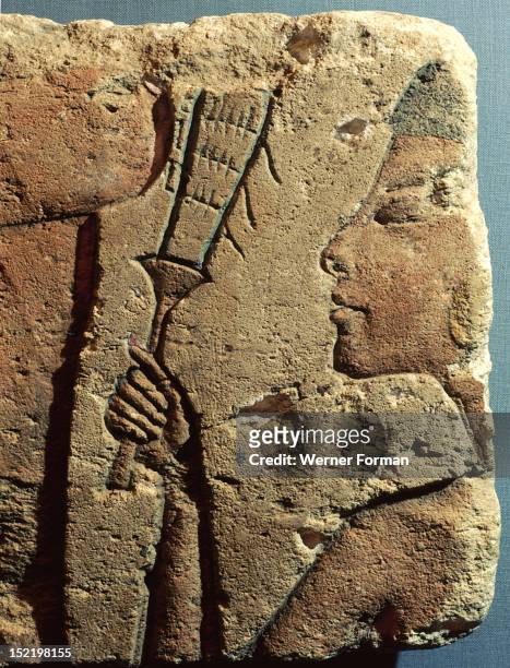 Fragment of a relief, A figure in a procession playing the sistrum. Egypt. Ancient Egyptian. 18th dynasty c 1352 1336 BC. Amarna period.