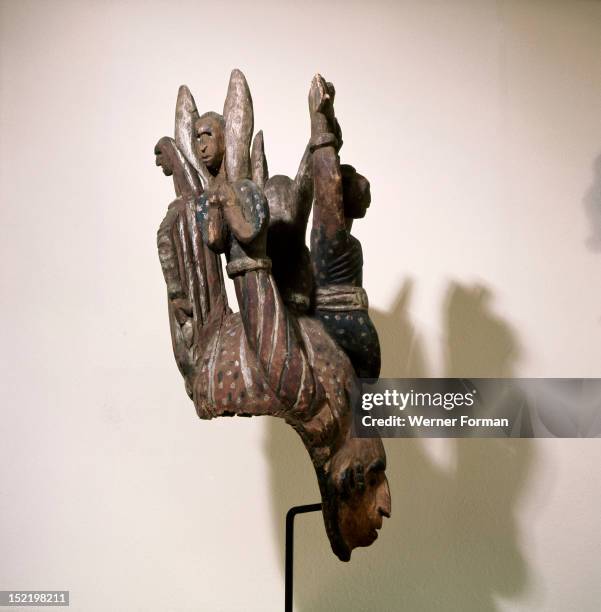 An Igbo mask of the white faced type that usually represent a beautiful girl, The crest is a rare depiction of the crucified Christ flanked by two...