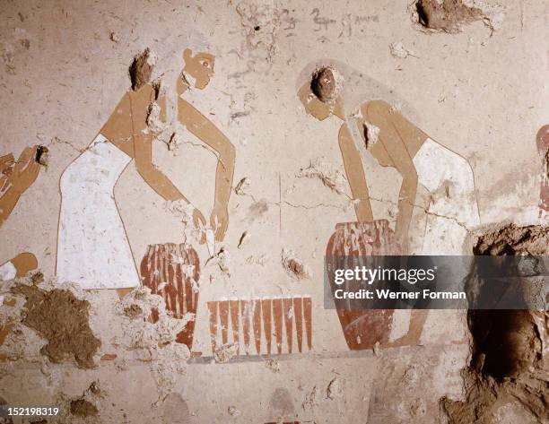 Painting detail in the tomb of Senet showing bread making, Moulds are filled with dough taken from large jars and then stacked for baking. Bread...