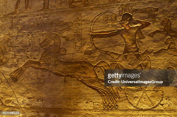 Egyptian art, Great Temple of Ramses II, 19th Dynasty, Military campaign against the Hittites, Ramses II in a chariot with a bow and arrow at the...