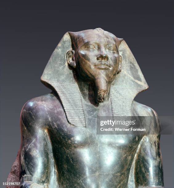 Statue of King Chephren, The god Horus in the shape of a falcon is sitting on the back of the throne protecting the king with his outstretched wings....