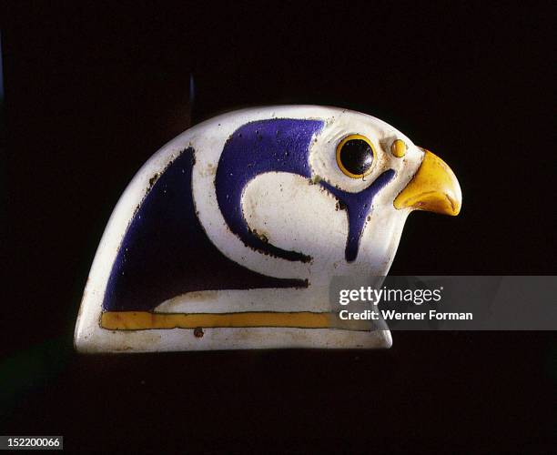 Glass falcon head, the terminal from a collar, Blue, yellow, and black glass inlays on a white ground. Egypt. Ancient Egyptian. C 3rd 1st c BC Graeco...