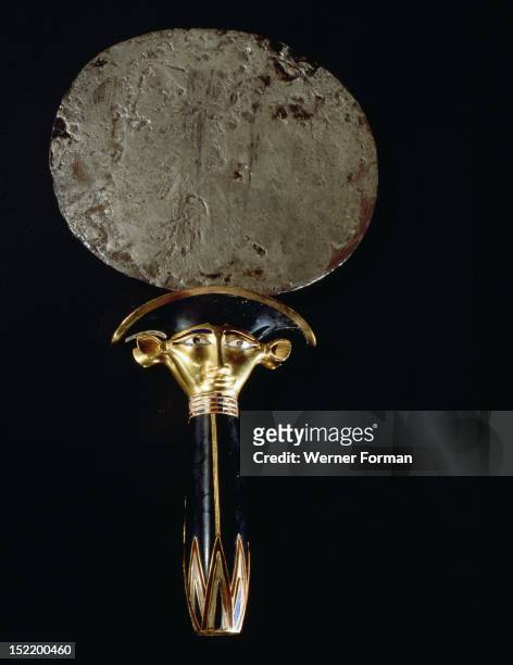 Silver mirror of princess Sathathoryunet, with handle in the form of a papyrus stem and the double sided face of the cow goddess Hathor, Egypt....